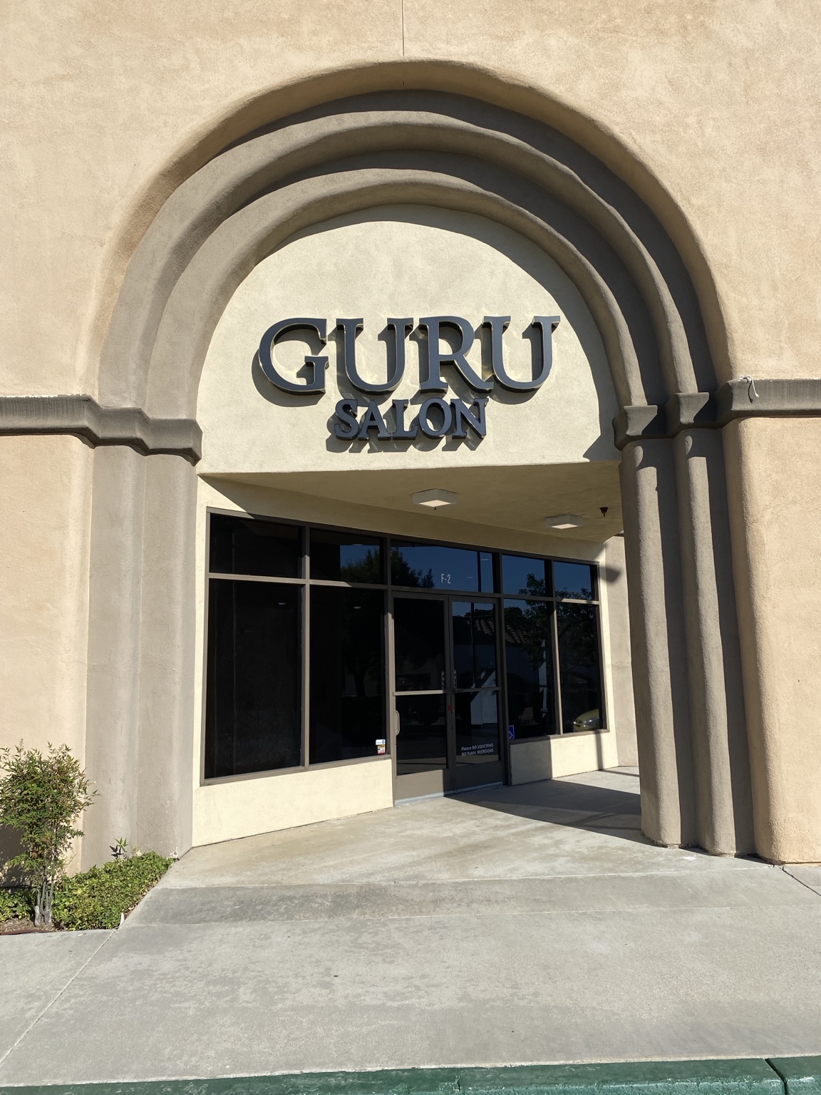 Guru storefront sign on an arched entrance