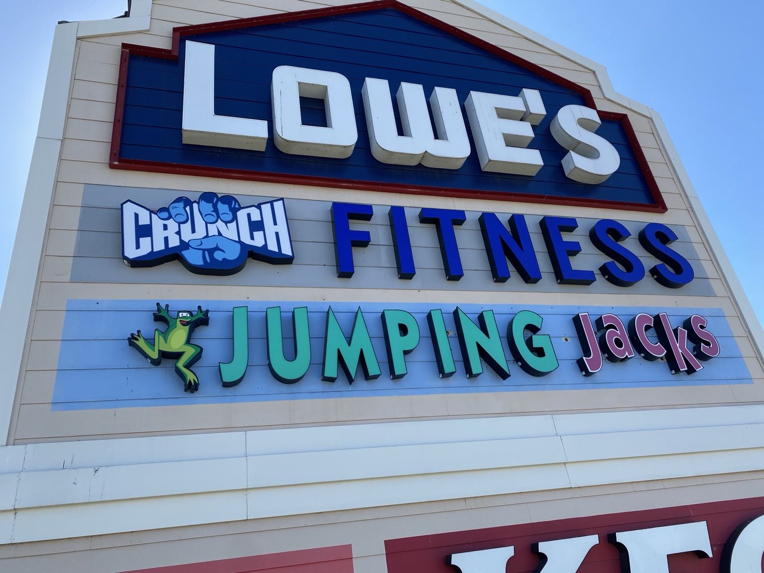 Exterior signs installed on a multi-brand storefront